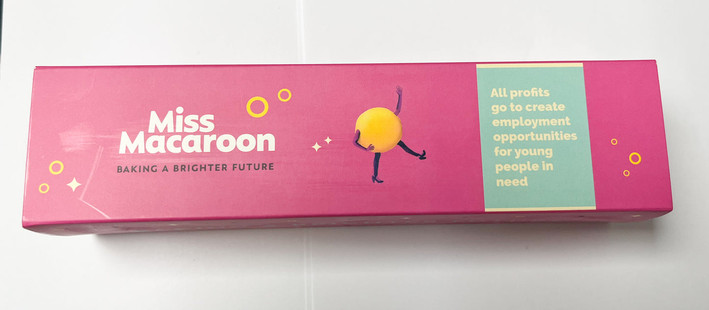 Pink box with 'Miss Macaroon' branding and a colorful character on a white background