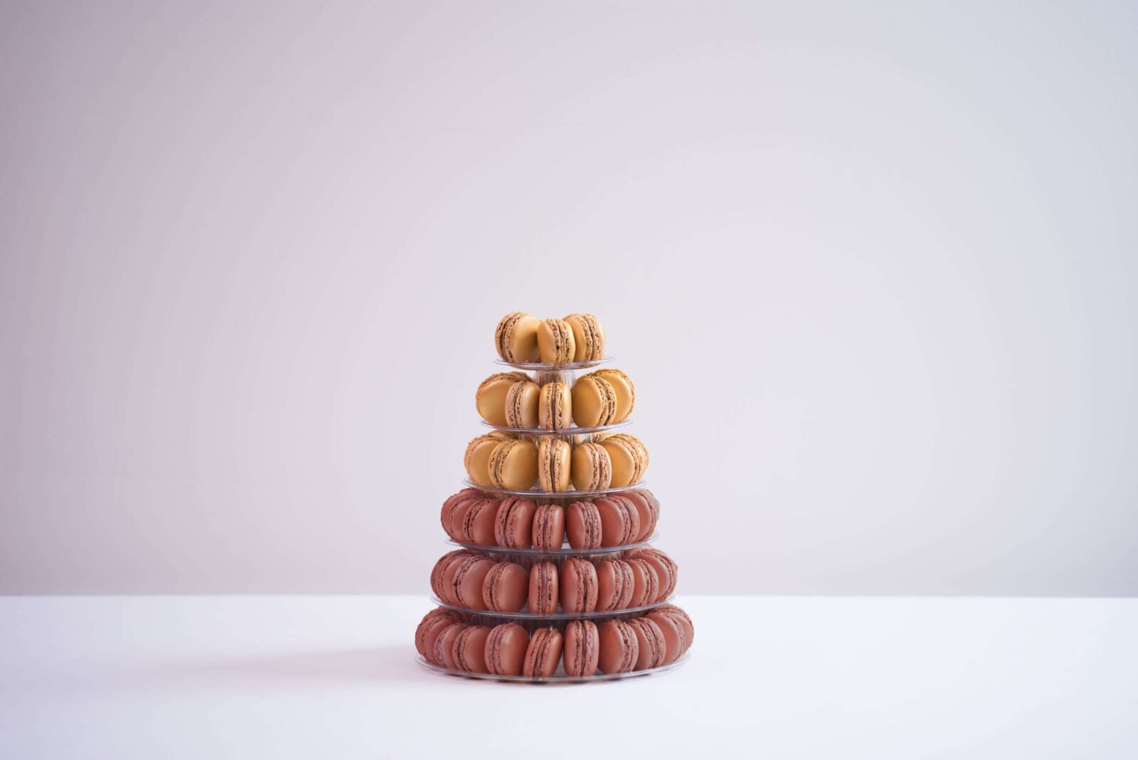 Six tier conical tower containing 105 macaroons, half green half yellow.