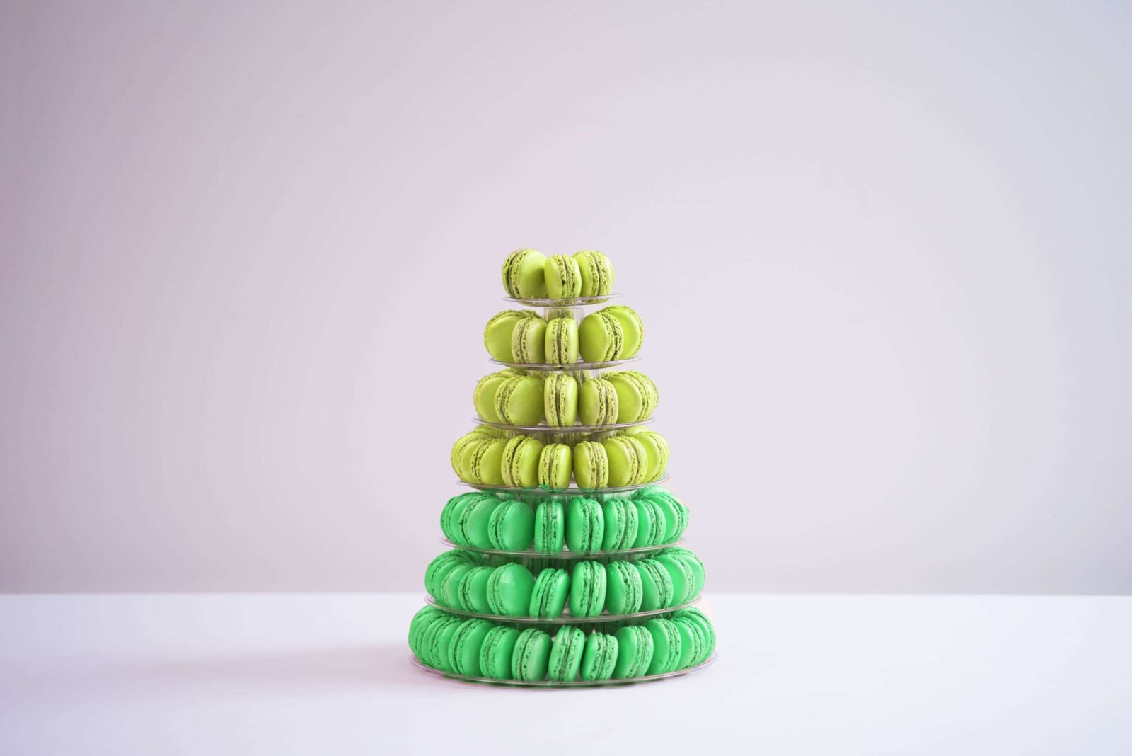 Seven tier conical tower containing 140 macaroons, half green half yellow.