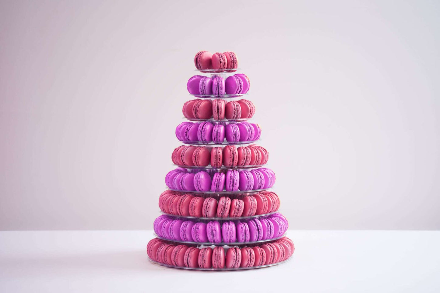 Nine tier conical tower containing 210 macaroons in purple and deep pink.