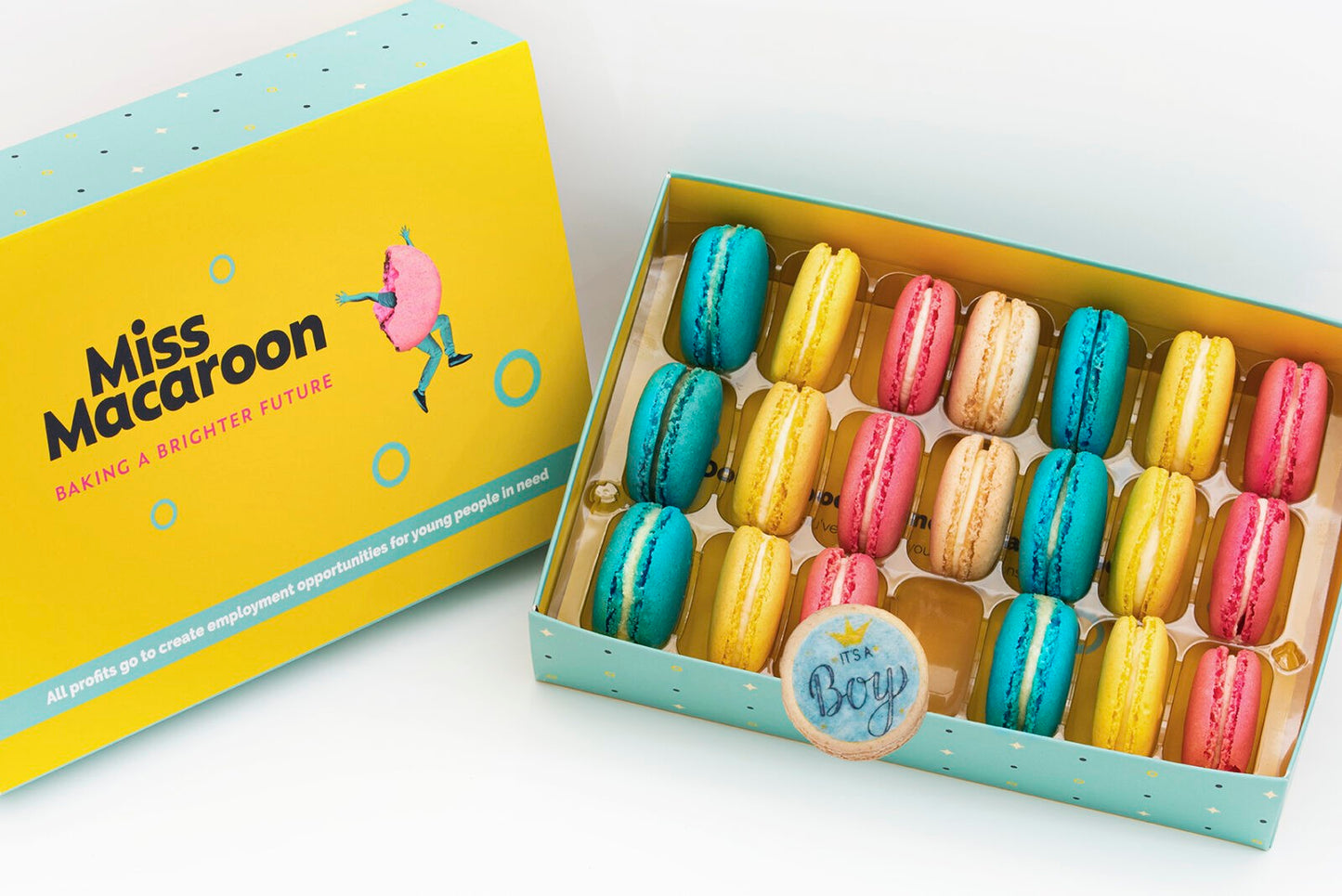 Gift box of 21 pink, yellow, cream and blue macaroons, with three printed with an 'it's a boy logo' with crown motif on.