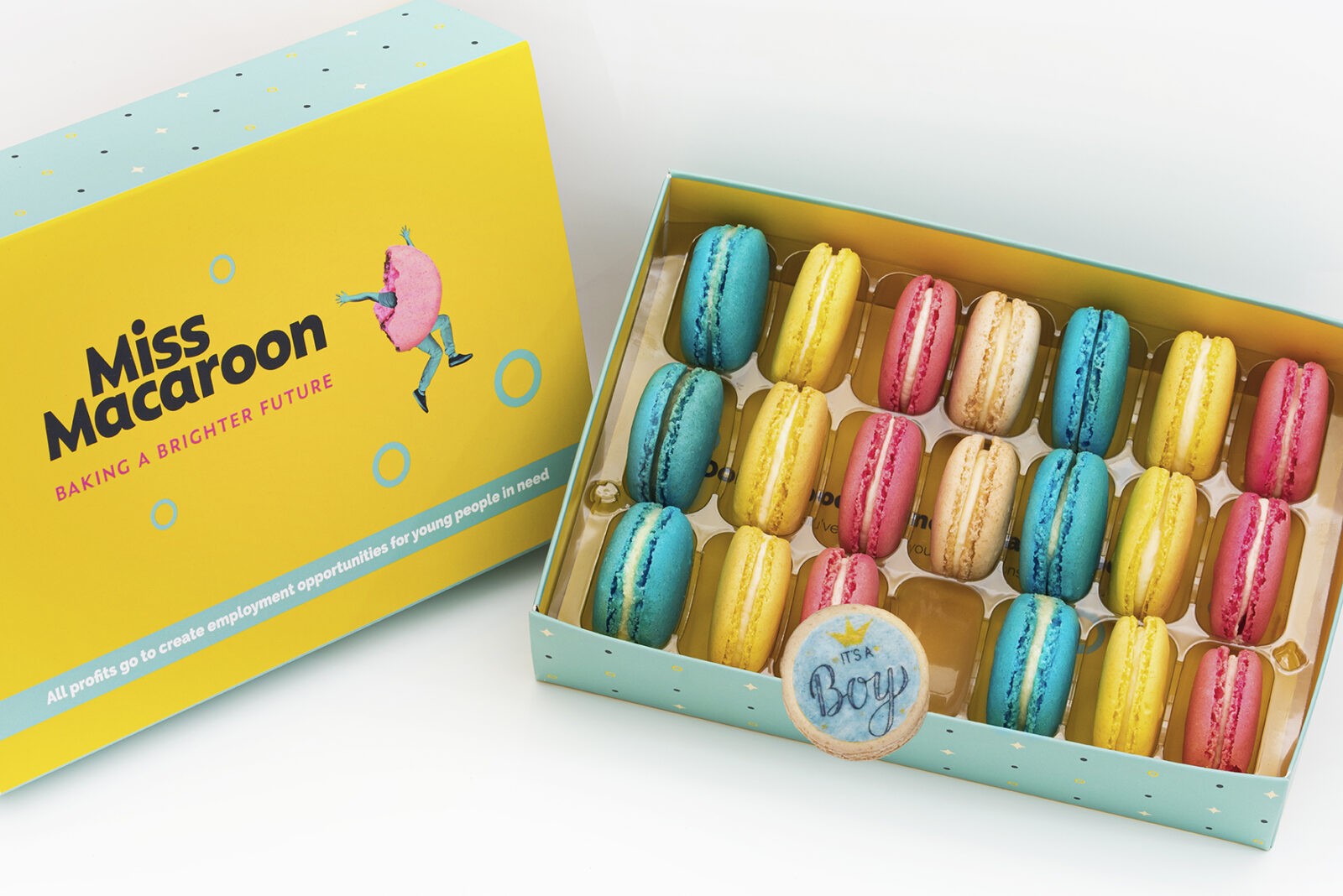 Gift box of 21 pink, yellow, cream and blue macaroons, with three printed with an 'it's a boy logo' with crown motif on.