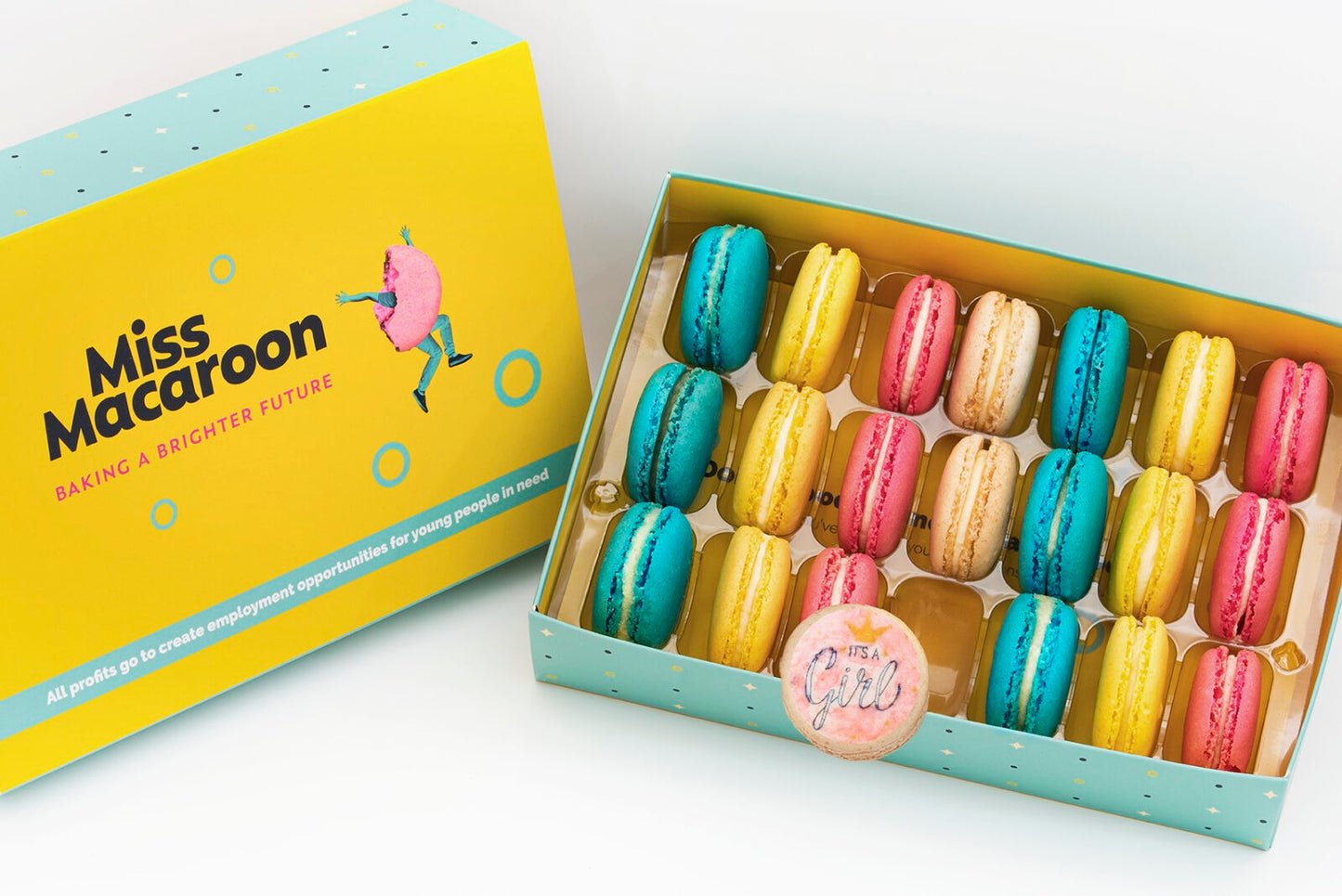 Gift box of 21 pink, yellow, cream and blue macaroons, with three printed with an 'it's a girl logo' with crown motif on.