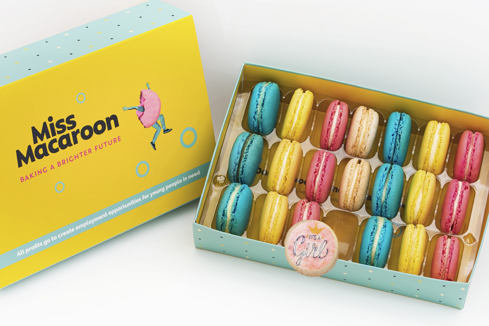 Gift box of 21 pink, yellow, cream and blue macaroons, with three printed with an 'it's a girl logo' with crown motif on.