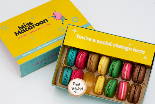 Gift box of 14 macaroons. Two of each flavour, seven different bright coloured macaroons, with "Best Teacher" printed on.