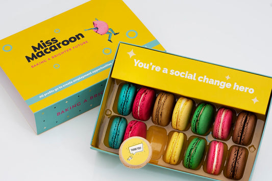 Gift box of 14 macaroons. Two of each flavour, seven different bright coloured macaroons, with "Thank you" in speech bubble and megaphone picture printed on.