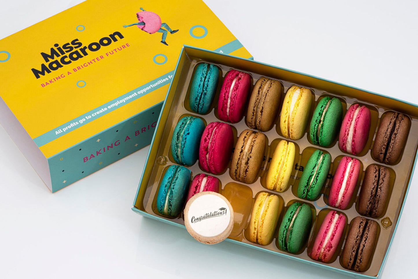 Gift box of 21 macaroons. Three of each flavour, seven different bright coloured macaroons, with "Congratulations" and picture of mortar board (graduations cap) printed on.