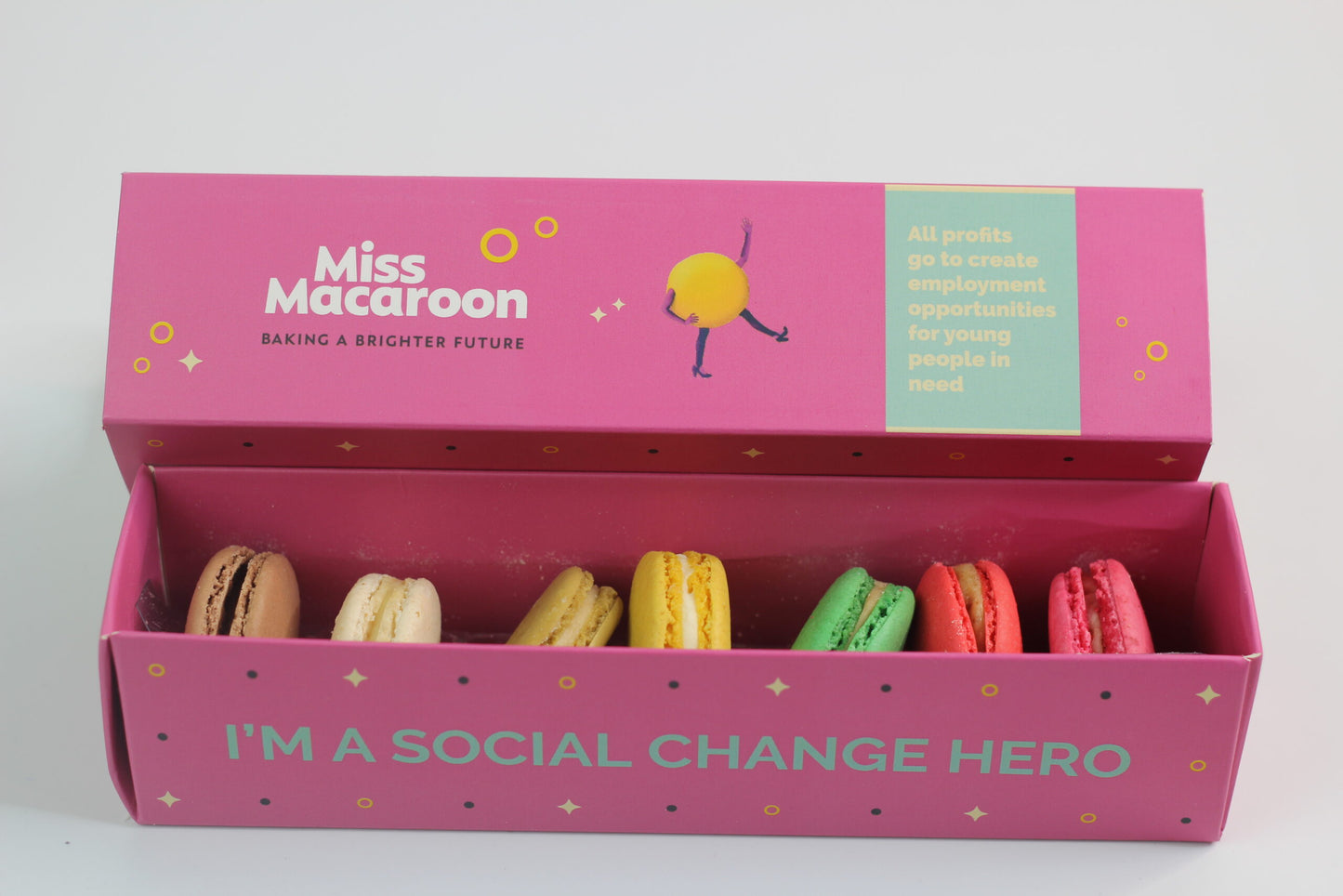 7 multi coloured Halal Macaroons displayed in a pink box