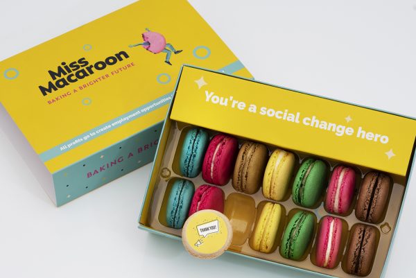 Gift box of 14 macaroons. Two of each flavour, seven different bright coloured macaroons, with "Thank you" in speech bubble and megaphone picture printed on.